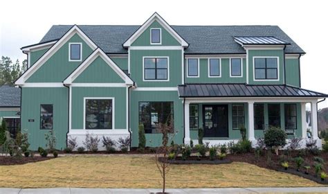 metal roof on mint green house|houses with green roof colors.